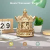 A wooden carousel music box is displayed on a table with a calendar and a plant. Anteprima dell’immagine prodotto
