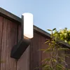 A modern outdoor wall light mounted on a wooden fence. Produktbild-Vorschau