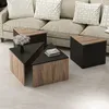 A set of triangular coffee tables in front of a sofa. Produktbild-Vorschau