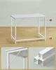 A white table with metal legs, shown from different angles. The table appears to be made of metal and wood. Produktbild-Vorschau