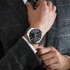 A man wearing a suit and watch. Podgląd zdjęcia produktu