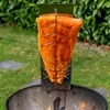 A large piece of salmon is being smoked over a grill outdoors. Náhľad obrázku produktu