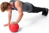 A man performing a push-up exercise with a red medicine ball. Produktbild-Vorschau