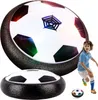 A boy playing with a hover soccer ball, with a larger hover soccer ball in the background. Produktbild-Vorschau