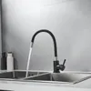 A black flexible kitchen faucet with water running into a stainless steel sink. Náhľad obrázku produktu