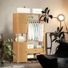 A wooden wardrobe with clothes hanging on a rack and shelves with folded clothes and boxes. Náhled obrázku produktu
