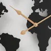 A close-up view of a world map wall clock with black landmasses and light-colored hands. Podgląd zdjęcia produktu