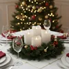 A Christmas table setting with a centerpiece of LED candles and a decorated Christmas tree in the background. Produktbild-Vorschau