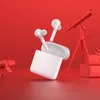 A pair of white wireless earbuds and their charging case are displayed against a red background, with a telescope and other red objects in the background. Náhľad obrázku produktu