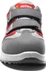 A close-up, front-facing view of a red and gray work shoe with Velcro straps. Produktbild-Vorschau