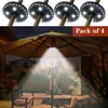 An outdoor patio scene at night, illuminated by umbrella lights. Produktbild-Vorschau