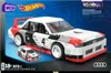 The image shows the packaging of a Mega Hot Wheels Collector Audi 90 Quattro IMSA GTO building set. The packaging features a large image of the assembled model car, a smaller image of the die-cast car included, and branding from Mega and Hot Wheels. Anteprima dell’immagine prodotto