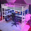 A loft bed with a desk and storage underneath, set up in a room with ambient lighting. Anteprima dell’immagine prodotto