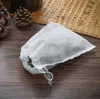 A white drawstring bag filled with tea leaves, placed on a wooden surface. Anteprima dell’immagine prodotto