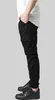 A person wearing black cargo jogging pants and black sneakers, shown from the side. Anteprima dell’immagine prodotto