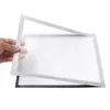A hand holding a magnetic photo frame over another frame. Náhľad obrázku produktu