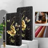A black flip phone case with gold butterfly designs is displayed next to a similar case. A small inset shows different colors of leather. Produktbild-Vorschau