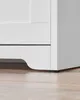 Close-up of the bottom corner of a white piece of furniture. Produktbild-Vorschau