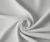 A close-up view of white fabric, folded and swirled into a spiral. Produktbild-Vorschau