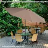 An outdoor patio setting with a table and chairs under a large umbrella. Voir les images du produit