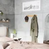 A bedroom scene with a coat and hat hanging on a wall-mounted hook rack. Podgląd zdjęcia produktu