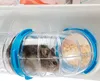 A hamster is inside a clear plastic tube with blue connectors, which is part of a larger enclosure. Produktbild-Vorschau