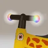 A close-up of the handlebars and front of a yellow giraffe-themed ride-on toy. Anteprima dell’immagine prodotto