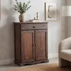 A vintage-style wooden cabinet with a drawer and two doors, decorated with a vase of eucalyptus and a candlestick on top. Náhľad obrázku produktu