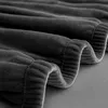 A close-up view of a dark gray fabric, likely a sofa cover, showing its textured surface and stitching. Podgląd zdjęcia produktu