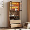 A tall, modern wooden cabinet with glass doors and LED lighting, designed for storing wine and spirits, is shown in a room setting. Náhled obrázku produktu