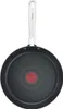 A black frying pan with a silver handle is shown from the bottom view, against a white background. Voir les images du produit