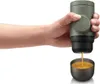 A hand holding a portable espresso maker, with espresso pouring into a cup. Produktbild-Vorschau