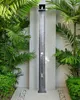 An outdoor shower surrounded by lush green plants. Náhľad obrázku produktu