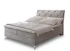A gray upholstered boxspring bed with a tufted headboard and bedding is shown against a white background. Produktbild-Vorschau