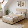 A bedroom with a bed, nightstand, and window. Náhled obrázku produktu