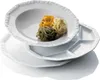 A stack of white porcelain plates with pasta nests on the top plate. Produktbild-Vorschau