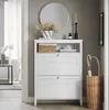 A white shoe cabinet with two louvered drawers, a woven basket, and decorative items on top. An umbrella stand with umbrellas is placed next to the cabinet. The scene is set in a hallway. Anteprima dell’immagine prodotto