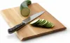 A cutting board with a zucchini and sliced zucchini. Voir les images du produit