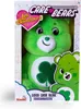 A green Care Bear plush toy is displayed in its retail packaging. The packaging features the Care Bears logo and branding, along with the specific character's name. Produktbild-Vorschau