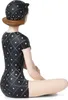 A figurine of a woman in a vintage-style swimsuit and cap, sitting cross-legged. Anteprima dell’immagine prodotto