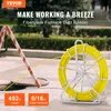 A yellow fiberglass fishtape duct rodder on a stand, with a construction barrier and a manhole cover in the foreground. Náhled obrázku produktu