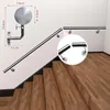 A stainless steel handrail installed on a staircase against a white wall, with close-up insets showing mounting details. Produktbild-Vorschau