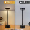 A split image showing a black LED table lamp in two states: on and off. The left side shows the lamp illuminated, casting a warm glow, with the German word "EIN" (ON) at the top. The right side shows the lamp unlit, with the German word "AUS" (OFF) at the  Náhľad obrázku produktu