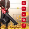 A person is using a red and black leaf blower outdoors in an environment with fallen leaves. Produktbild-Vorschau