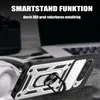 A phone case with a ring stand is shown in a close-up shot, with a laptop and headphones blurred in the background. Produktbild-Vorschau