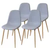Four light gray upholstered dining chairs with natural wood legs are arranged diagonally. Náhľad obrázku produktu