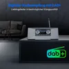 A modern living room setting with a sofa and a coffee table, featuring a digital radio. Produktbild-Vorschau