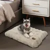 A Schnauzer dog is lying on a plush dog bed next to a nightstand and a bed. Anteprima dell’immagine prodotto