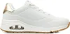 A side view of a white Skechers sneaker with gold accents and a gum sole. Náhled obrázku produktu