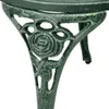 A close-up view of the ornate leg of a green bistro table, featuring a rose design. Voir les images du produit